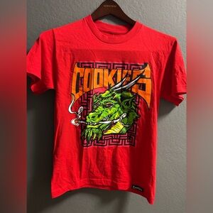 New Cookies SF Highest Of Highs red t-shirt with a graphic of a smoking dragon s